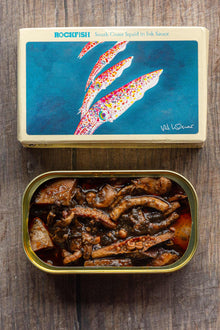 South Coast Squid in Ink Sauce packaging artwork by Val Warner and open tin showing squid in ink sauce