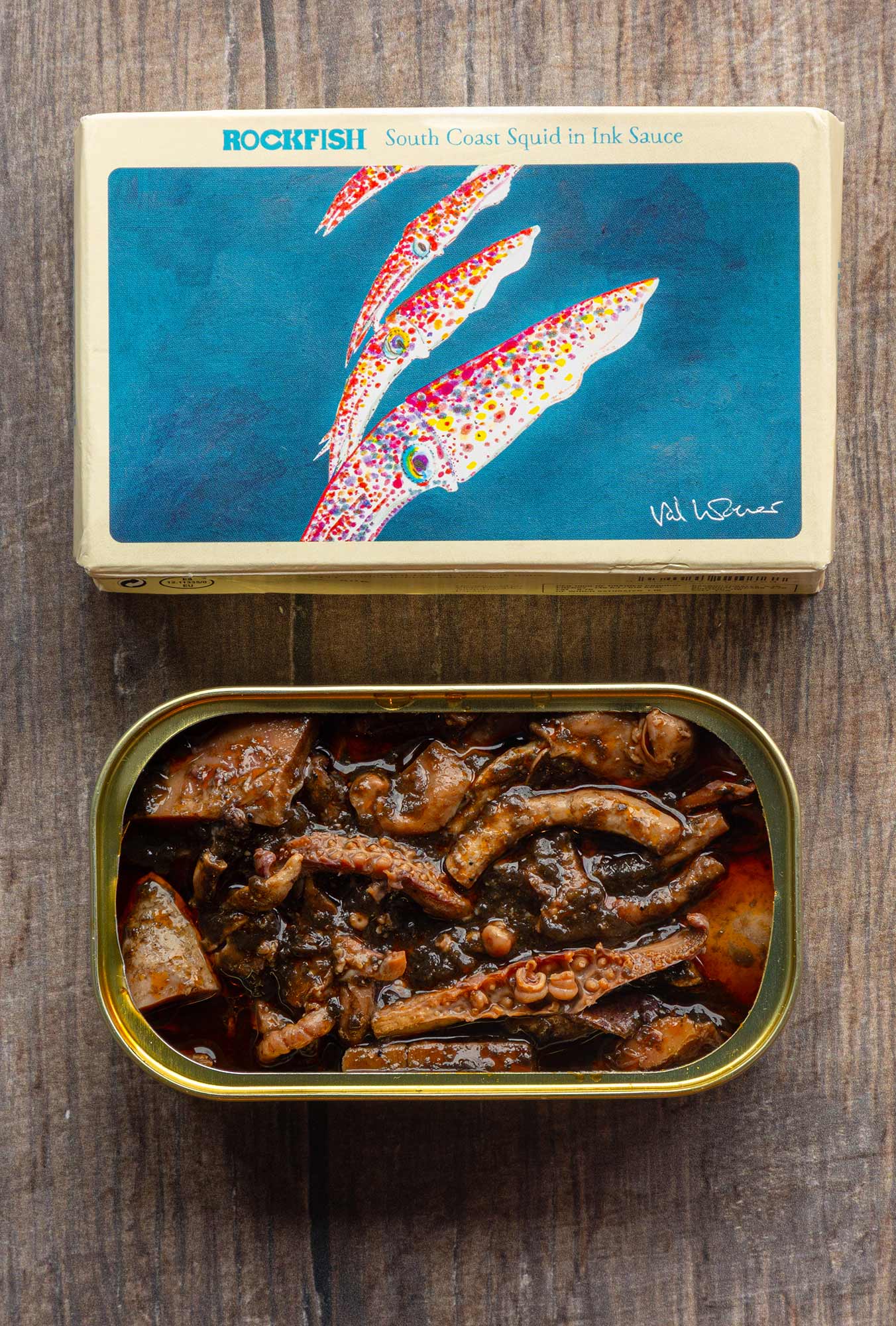 South Coast Squid in Ink Sauce packaging artwork by Val Warner and open tin showing squid in ink sauce
