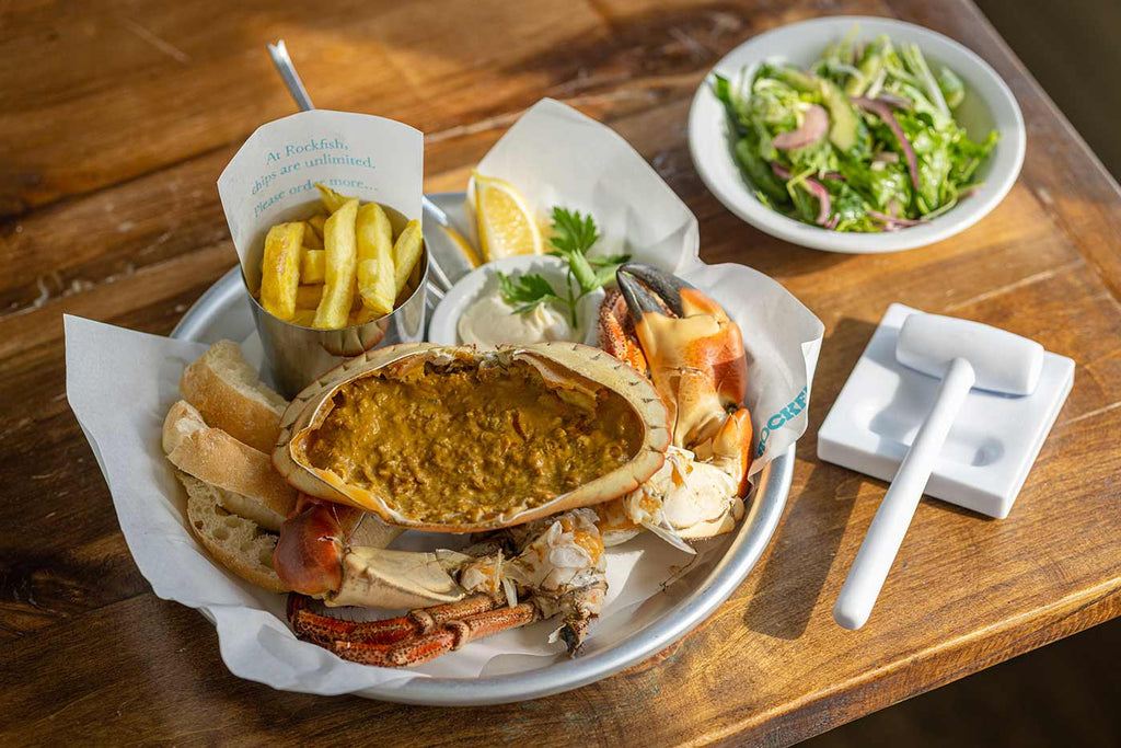 Whole dressed crab with a side salad and unlimited chips