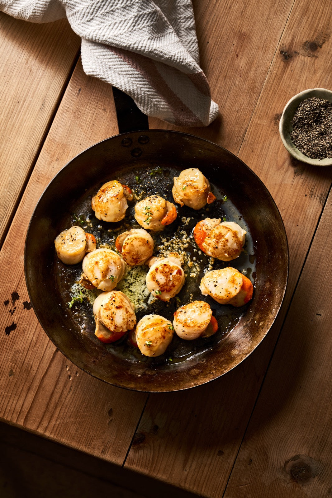 A portion of scallops from Rockfish Online Seafood Market cooked in a frying pan