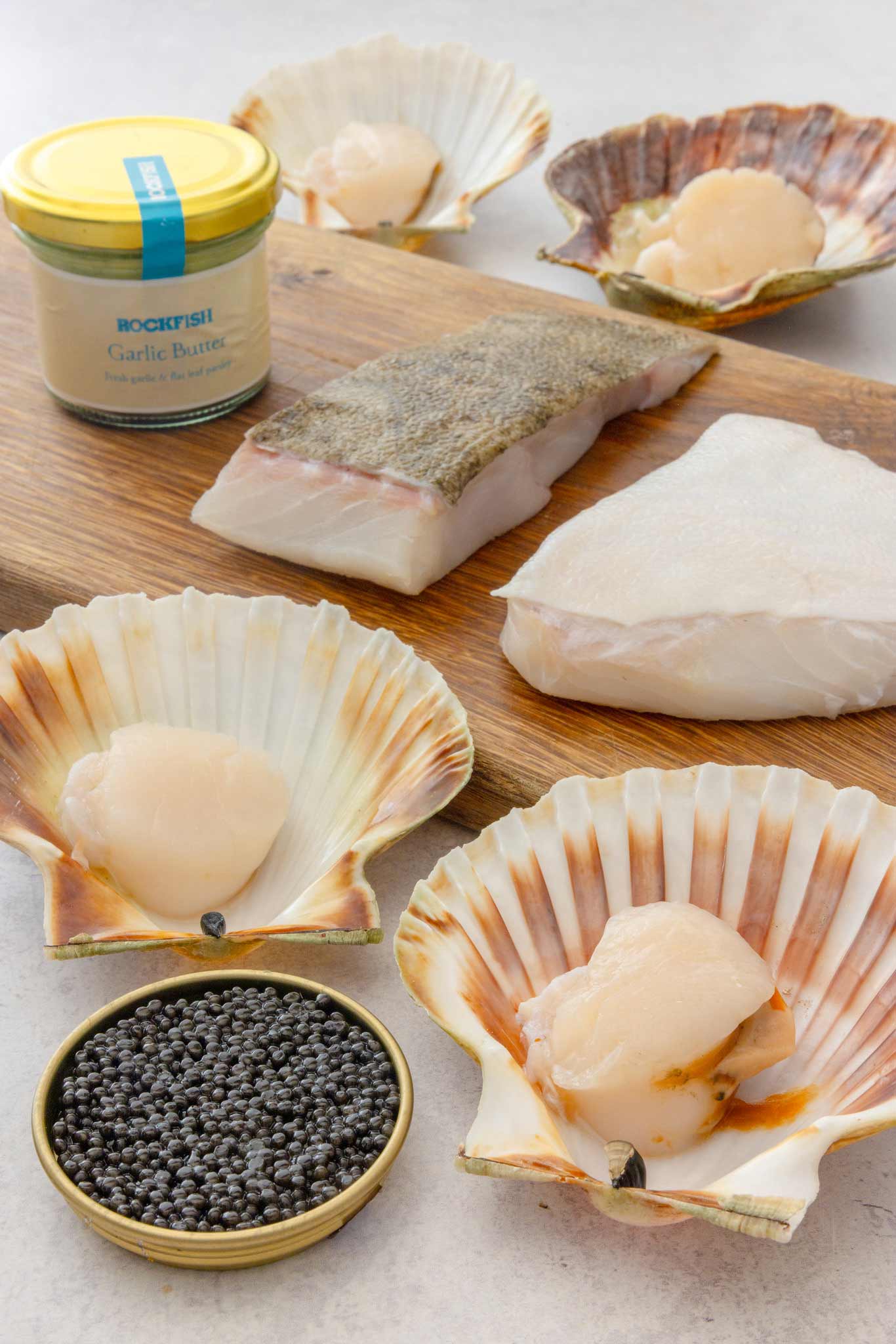 Valentine box from Rockfish laid out with caviar at the front surrounded by disco scallops and prime turbot fillets and a jar of garlic butter.