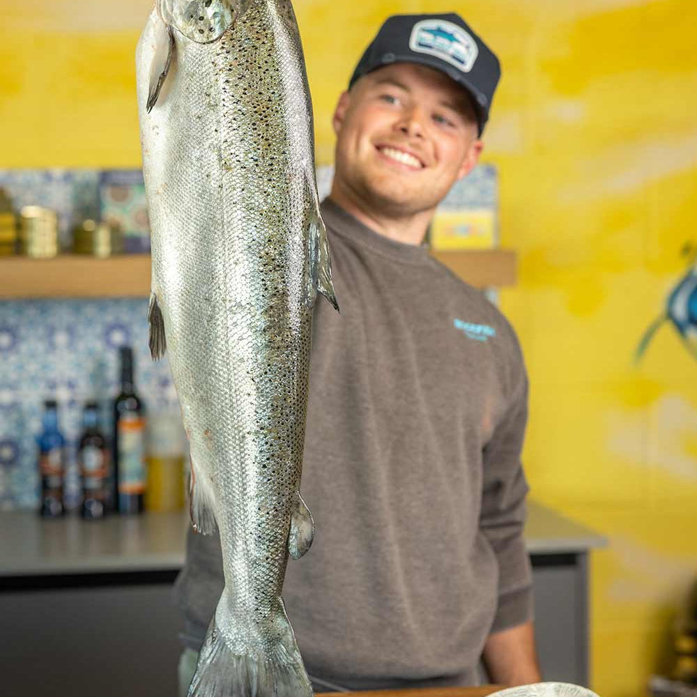 Tommy our fishmonger holding a Glenarm Salmon