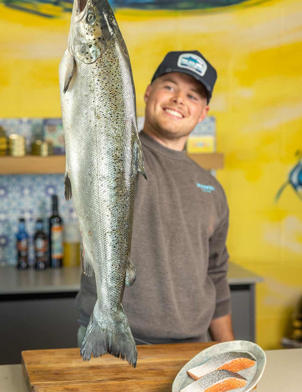 Tommy our fishmonger holding a Glenarm Salmon