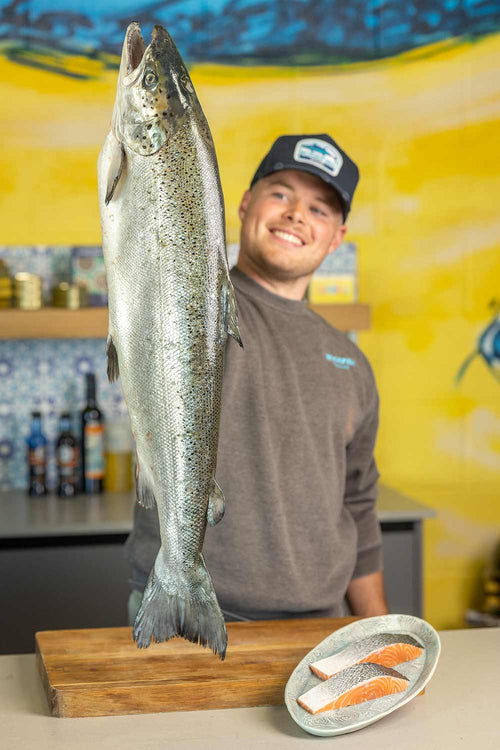 Tommy our fishmonger holding a Glenarm Salmon