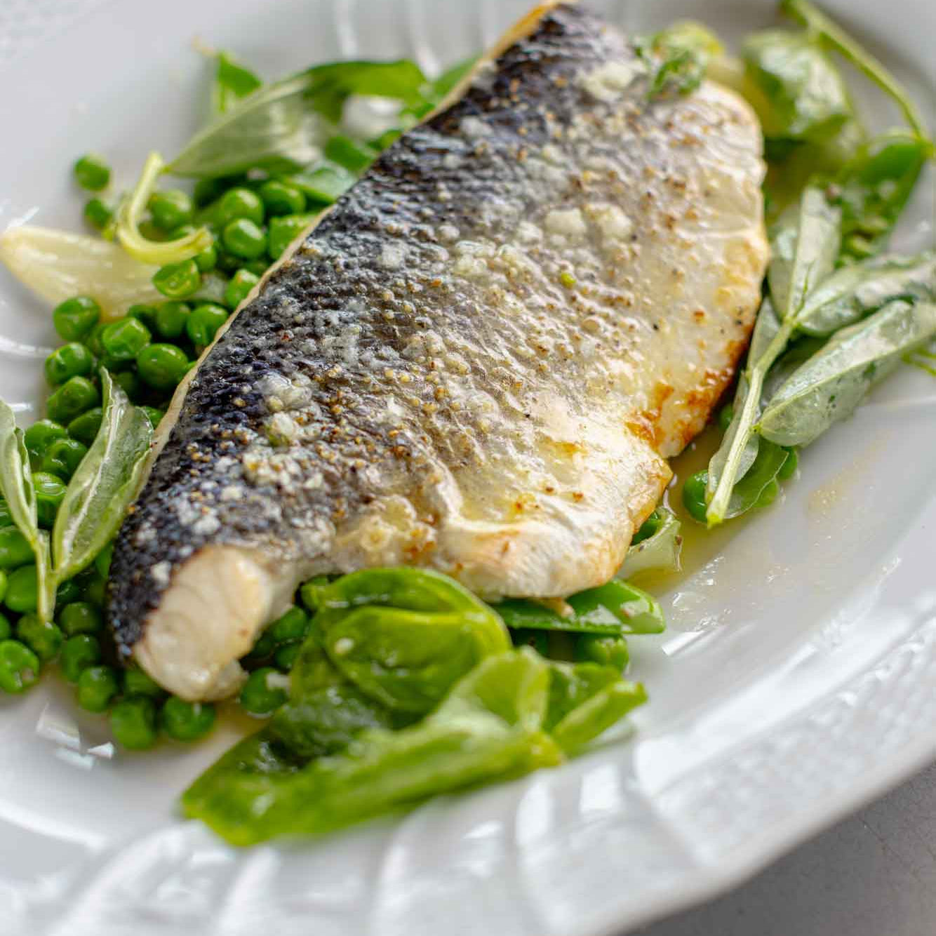 Rockfish sea bass fillet served with peas