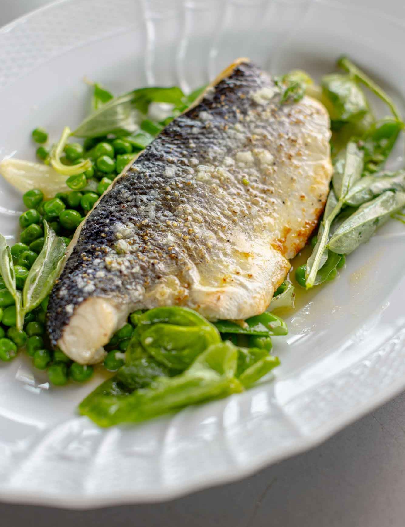 Rockfish sea bass fillet served with peas