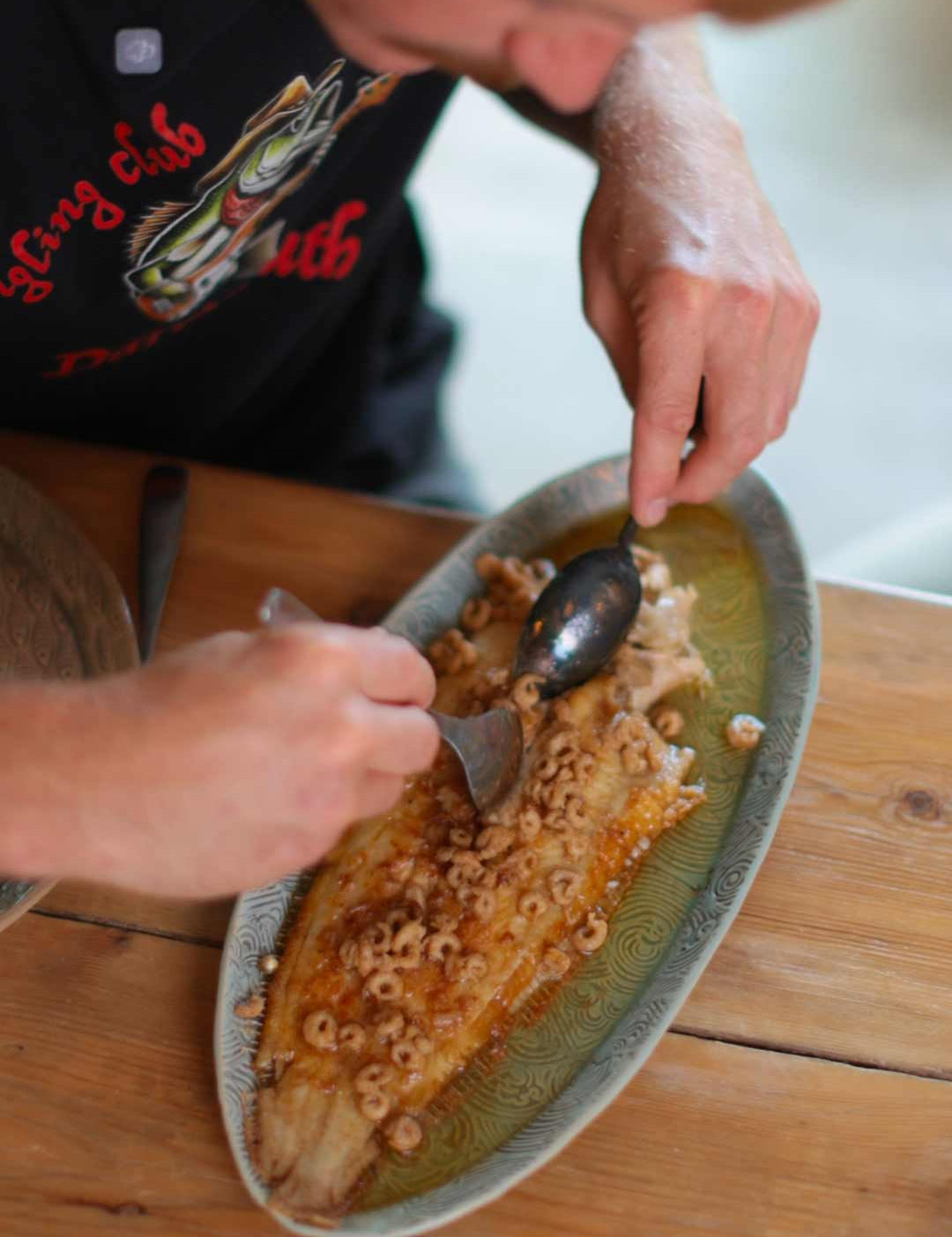 Alfie filleting a cooked Dover Sole meuniére with morecambe shrimp butter in the quayside kitchen