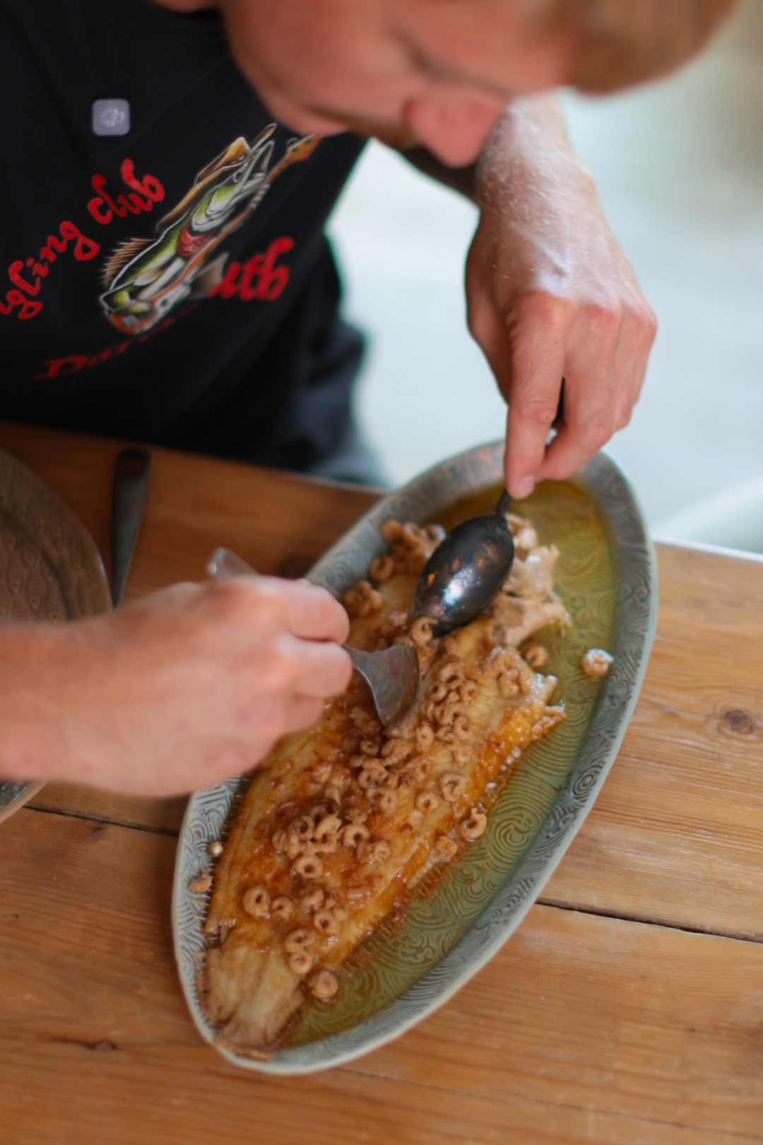 Alfie filleting a cooked Dover Sole meuniére with morecambe shrimp butter in the quayside kitchen