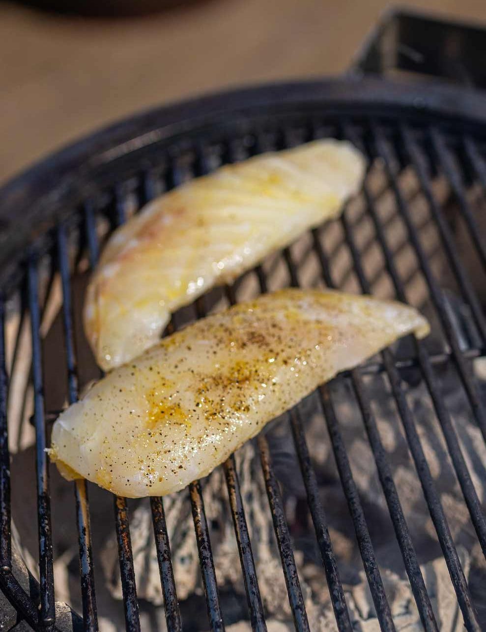Fillet of ling cooking on the BBQ grills