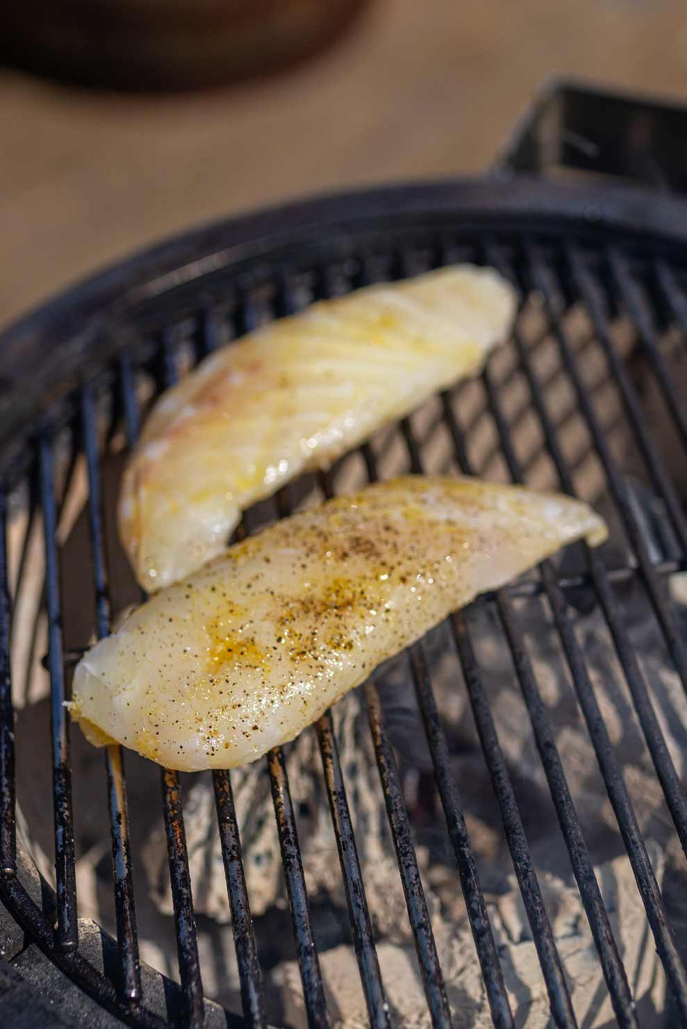 Fillet of ling cooking on the BBQ grills
