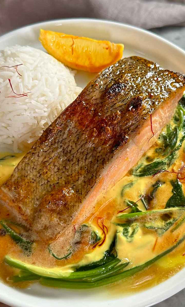 Plate of grilled trout and rice with orange & saffron sauce