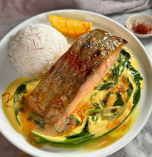 Plate of grilled trout and rice with orange & saffron sauce