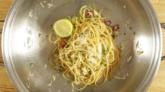 Spaghetti with crab, chilli and parsley in a pan