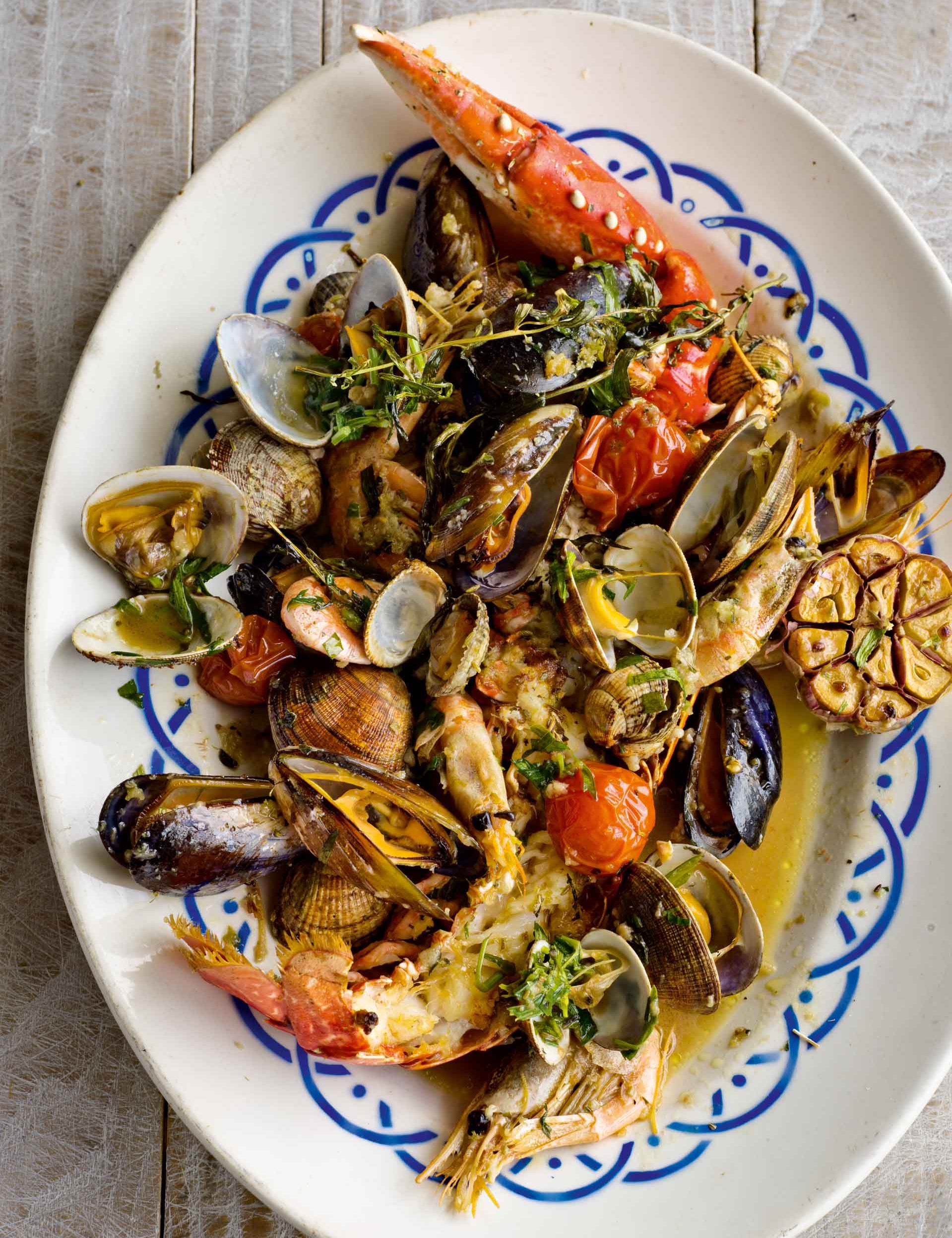 A plate of mixed roasted shellfish with tarragon and balsamic
