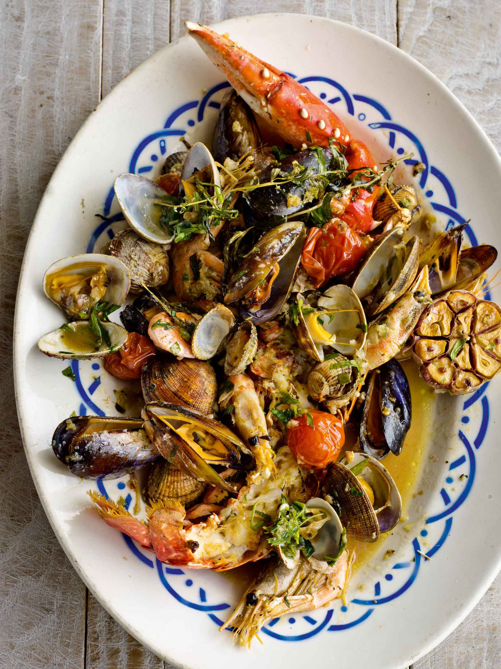 A plate of mixed roasted shellfish with tarragon and balsamic