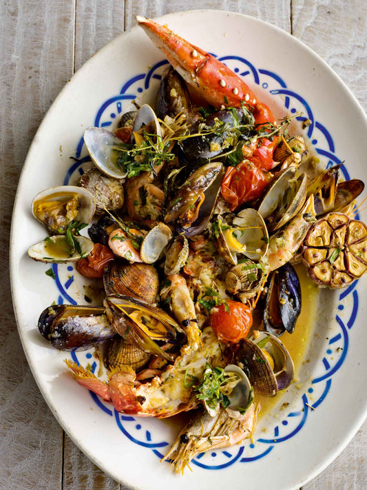 A plate of mixed roasted shellfish with tarragon and balsamic