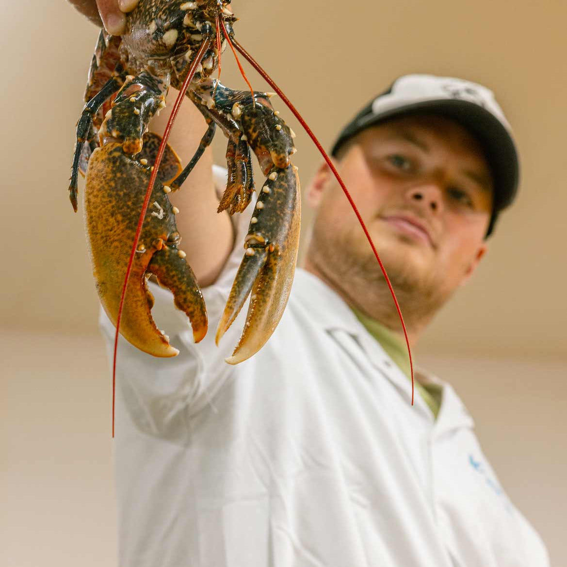 Our fishmonger Tommy holding a whole lobster