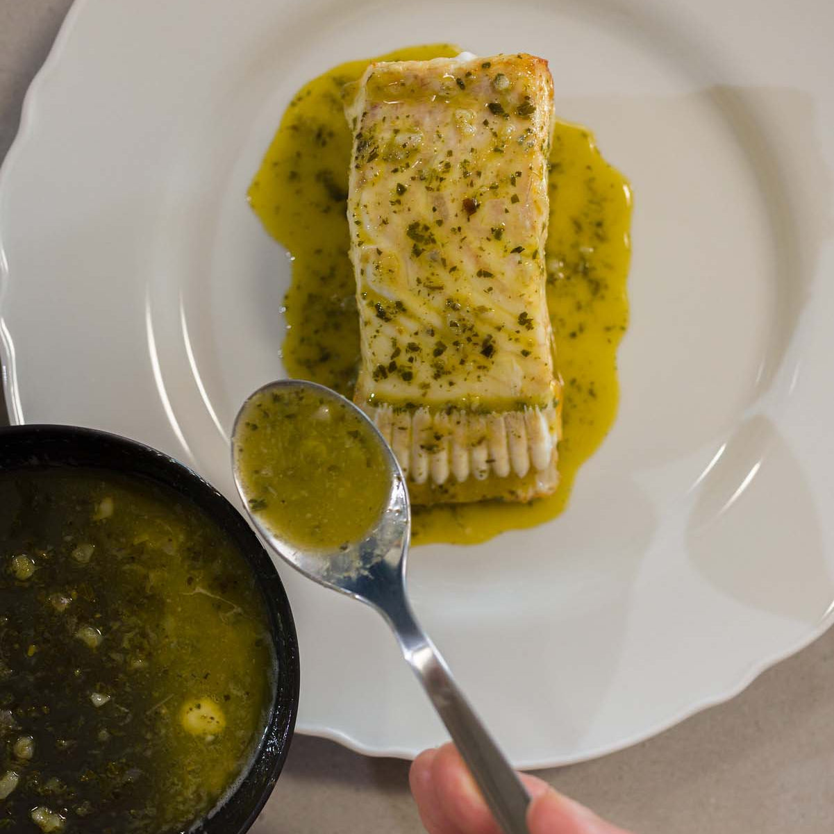 Turbot T-Bone on a plate being finished with butter