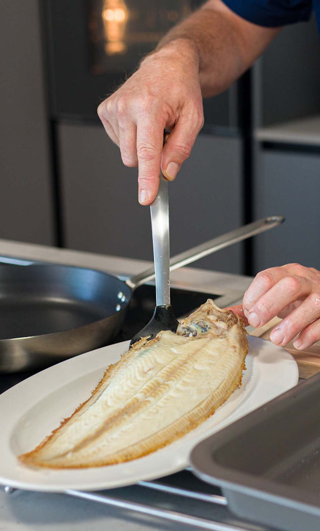 Dover Sole being plated after being cooked under the grill