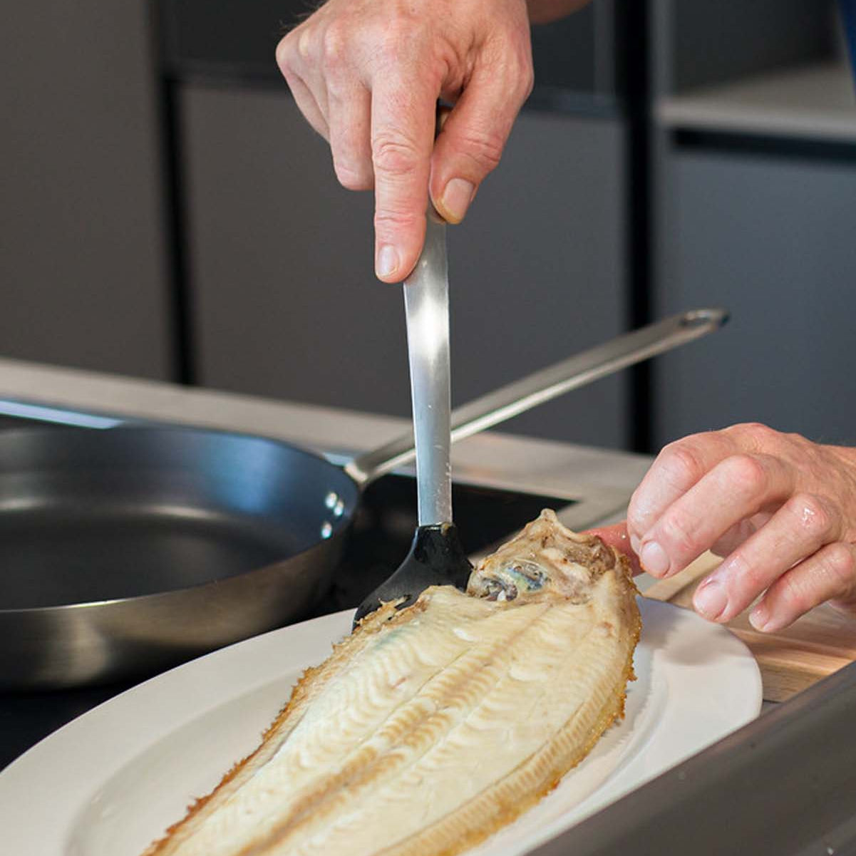 Dover Sole being plated after being cooked under the grill