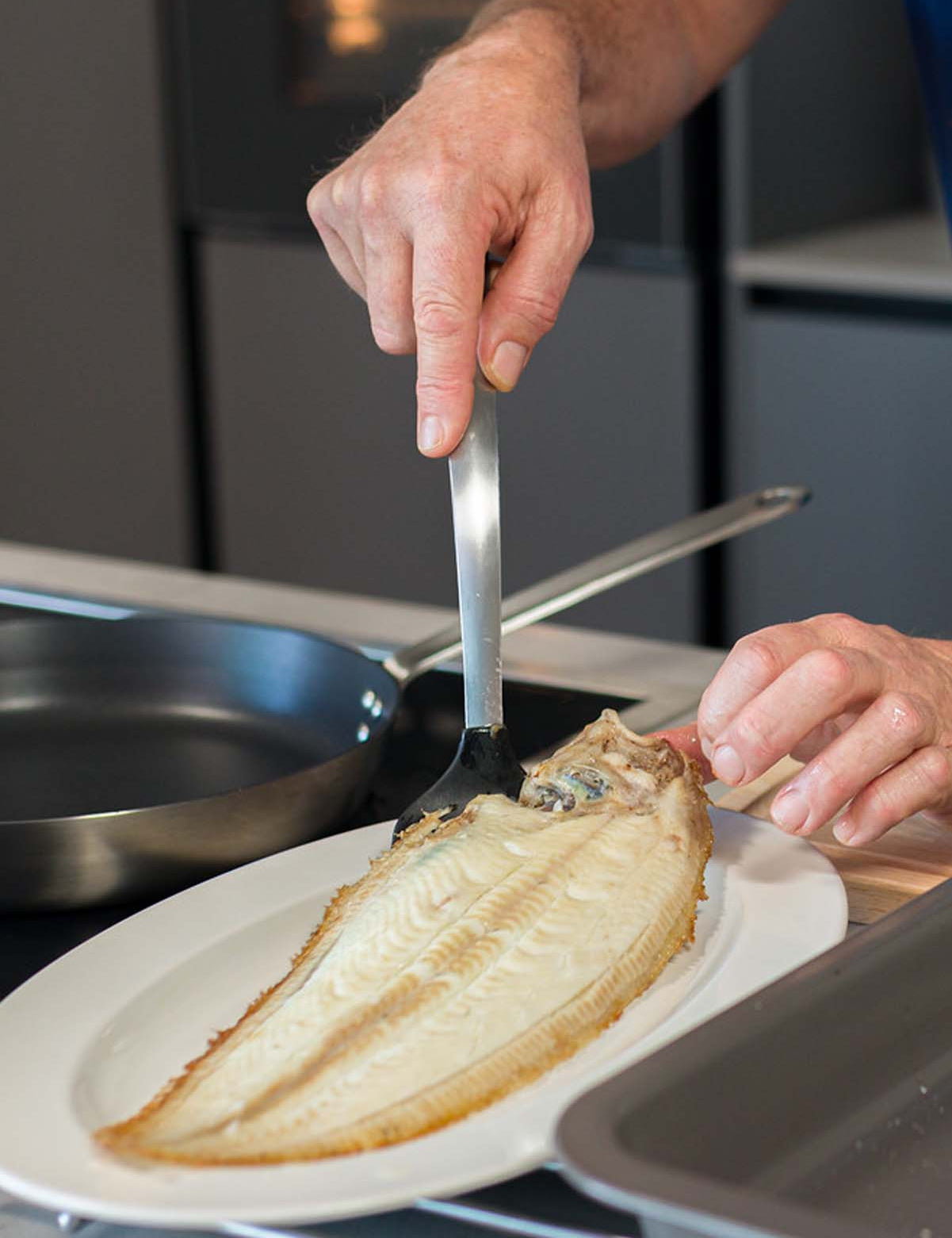 Dover Sole being plated after being cooked under the grill