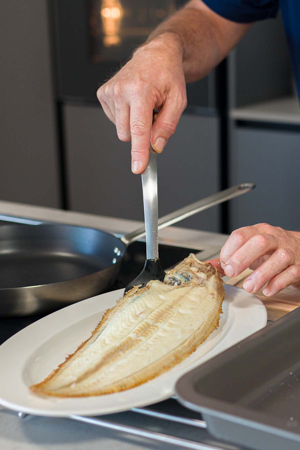 Dover Sole being plated after being cooked under the grill