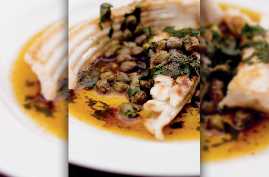 Close up of pan-fried skate wing with caper and black butter