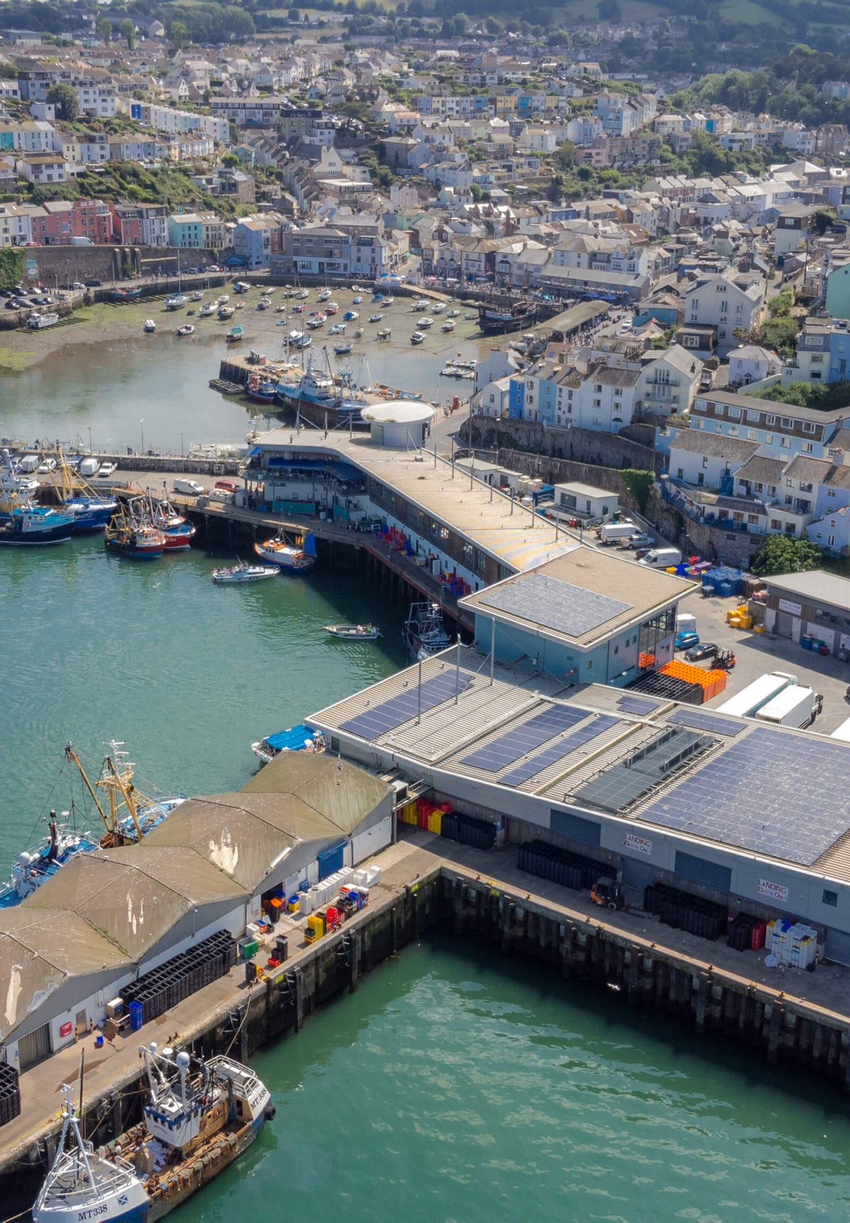 Brixham harbour from the air showing the fishing port and the town in the background