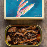 South Coast Squid in Ink Sauce packaging artwork by Val Warner and open tin showing squid in ink sauce