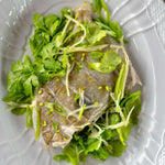 A whole john dory on the bone on a bed of herbs with ginger and mirin. A quick recipe to cook. John dory is available online daily from the Online Seafood Market and delivered across the UK the next day if ordered before 2pm