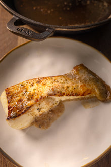 A portion of halibut from Rockfish delivered nationwide the next day sits under the whole fish