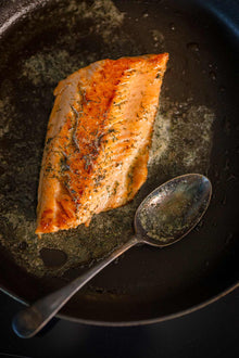 Wild trout fillets next to the whole fish