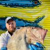 John Dory being held by fishmonger