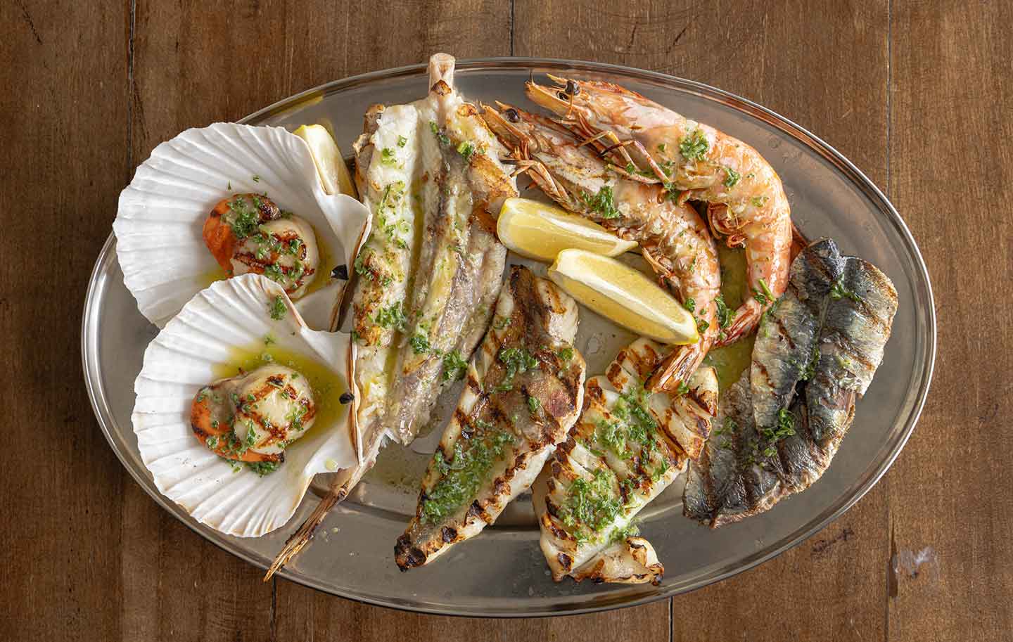 Mixed seafood grill by Rockfish includes: Monkfish, sardine, prawns, monkfish and scallops