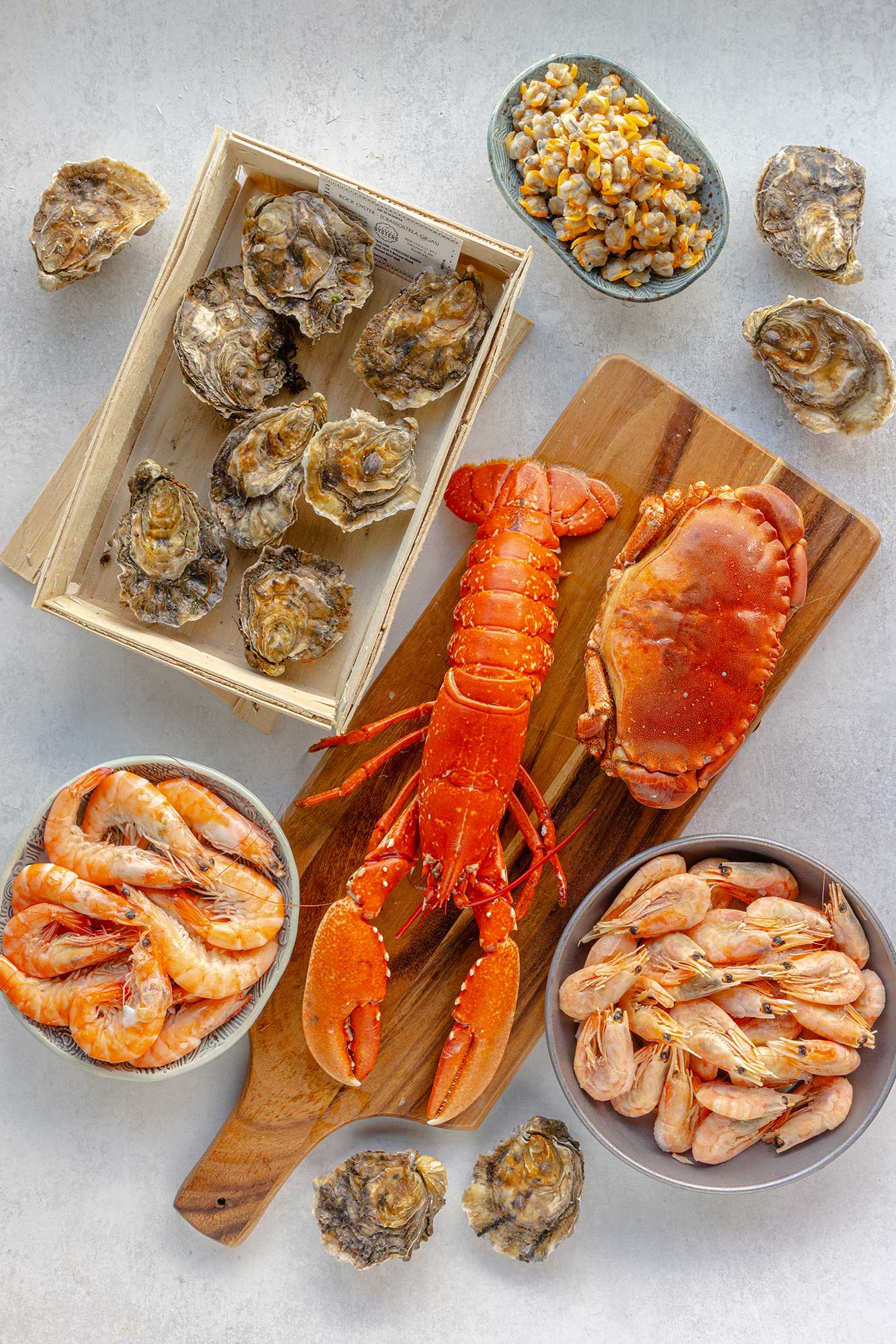 Top down view of a fruit de mer from Rockfish including, whole cooked lobster and crab, shell on prawns, crevettes, oysters and cockles.