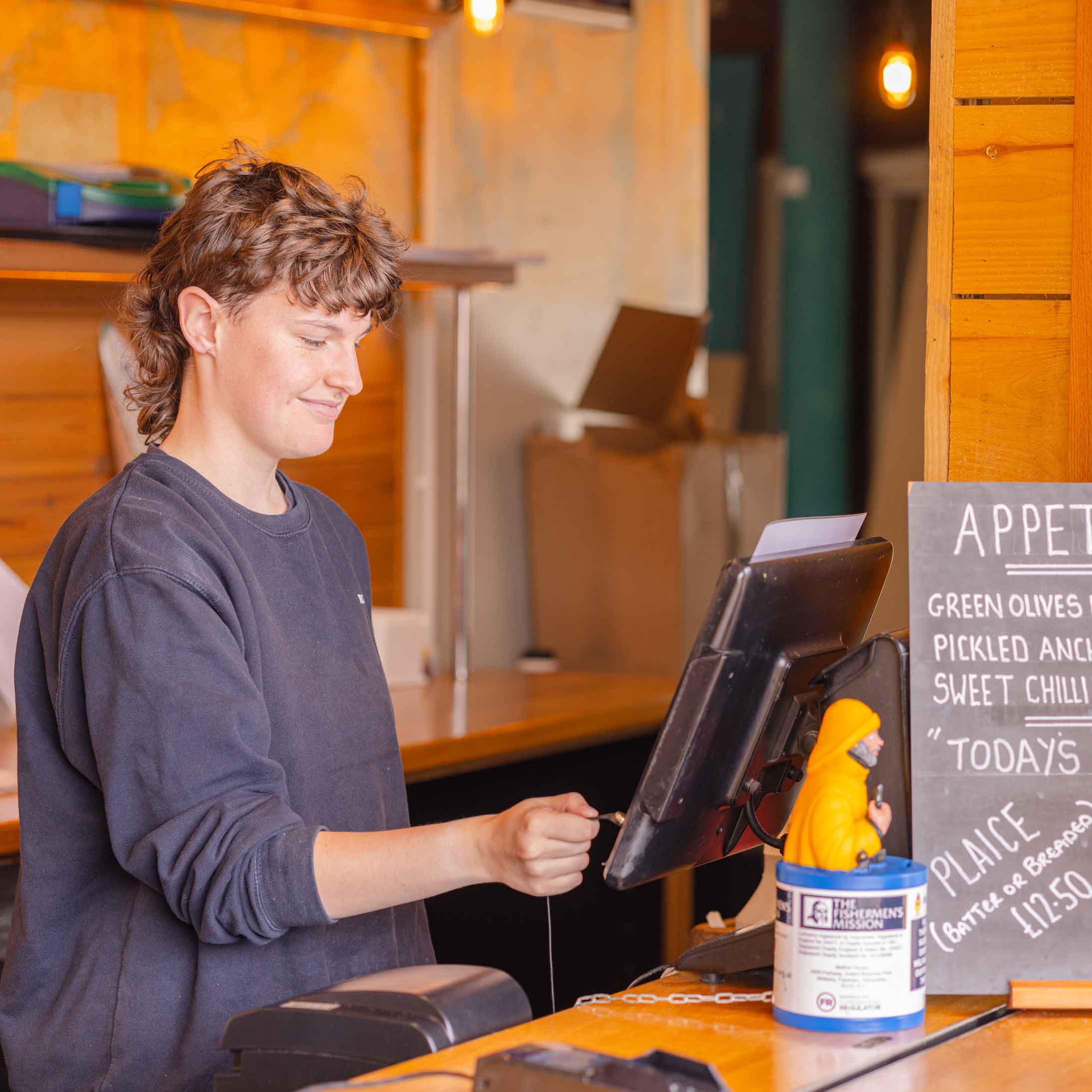 Rockfish member of staff serving a customer at Rockfish Plymouth takeaway