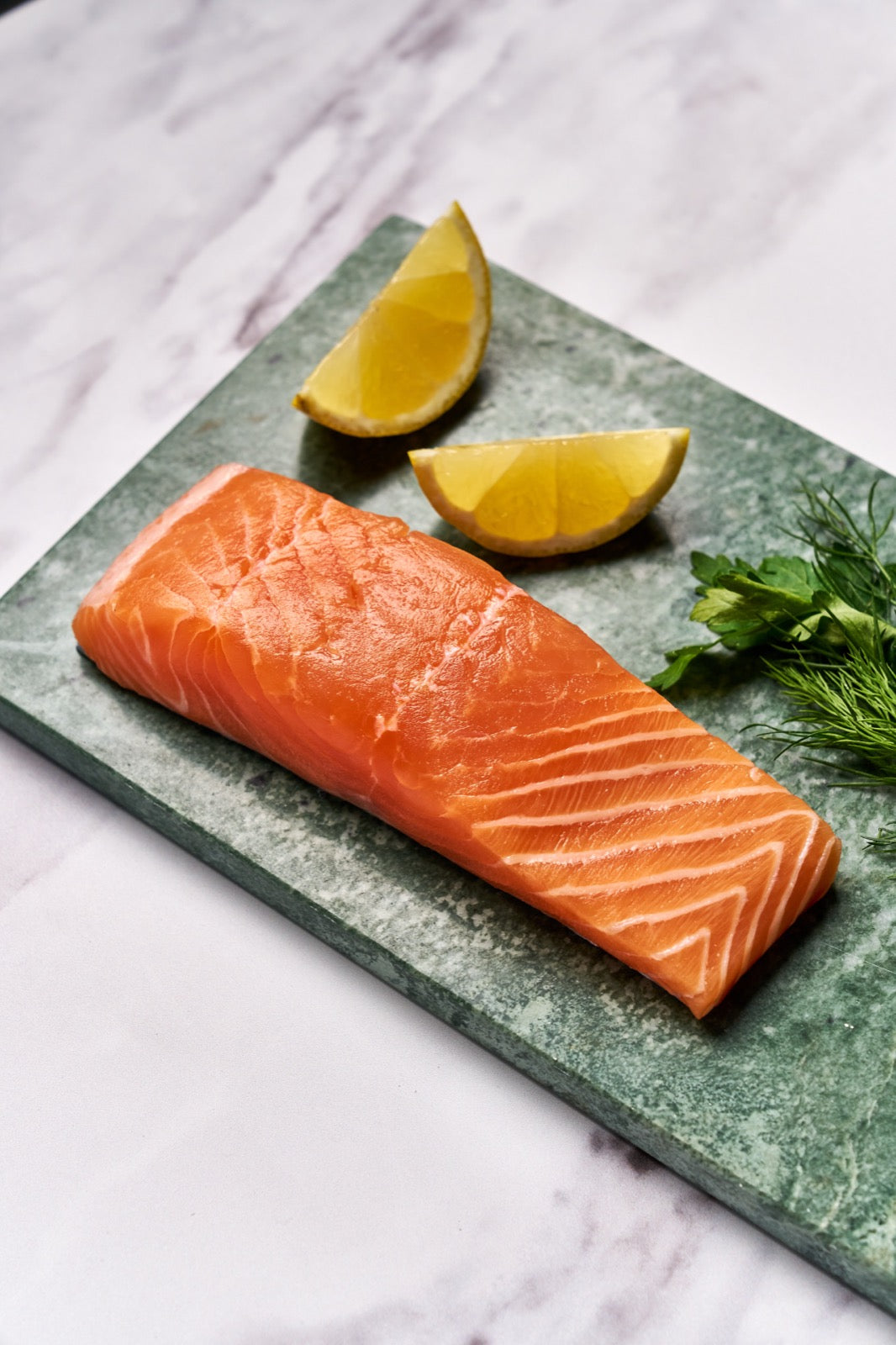 A portion of Glenarm Organic Salmon fillet from Rockfish Online Seafood Market on a piece of marble