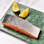 A portion of Salmon fillet from Rockfish Online Seafood Market on a piece of marble