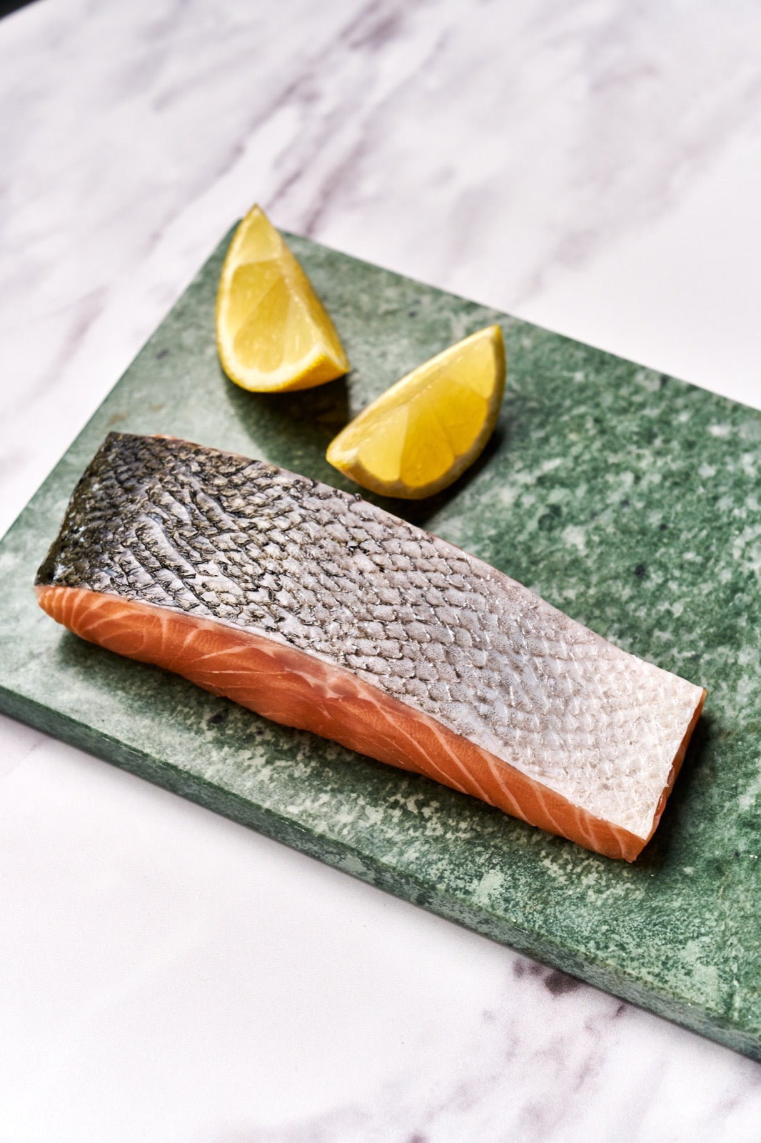 A portion of Salmon fillet from Rockfish Online Seafood Market on a piece of marble