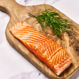 A portion of Chalk Stream Trout fillet from Rockfish Online Seafood Market on a wooden board