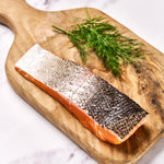 A portion of Chalk Stream Trout fillet from Rockfish Online Seafood Market on a wooden board