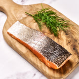 A portion of Chalk Stream Trout fillet from Rockfish Online Seafood Market on a wooden board