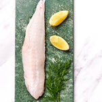 A portion of Monkfish fillet from Rockfish Online Seafood Market on a bpiece of marble