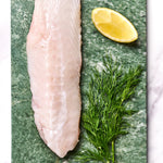 A portion of Monkfish fillet from Rockfish Online Seafood Market on a piece of marble