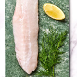 A portion of Monkfish fillet from Rockfish Online Seafood Market on a piece of marble