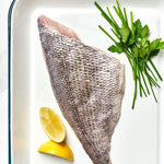 A portion of Black Bream fillet skin side up from Rockfish Online Seafood Market on a baking tray