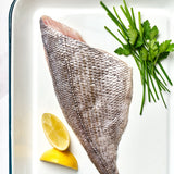 A portion of Black Bream fillet skin side up from Rockfish Online Seafood Market on a baking tray