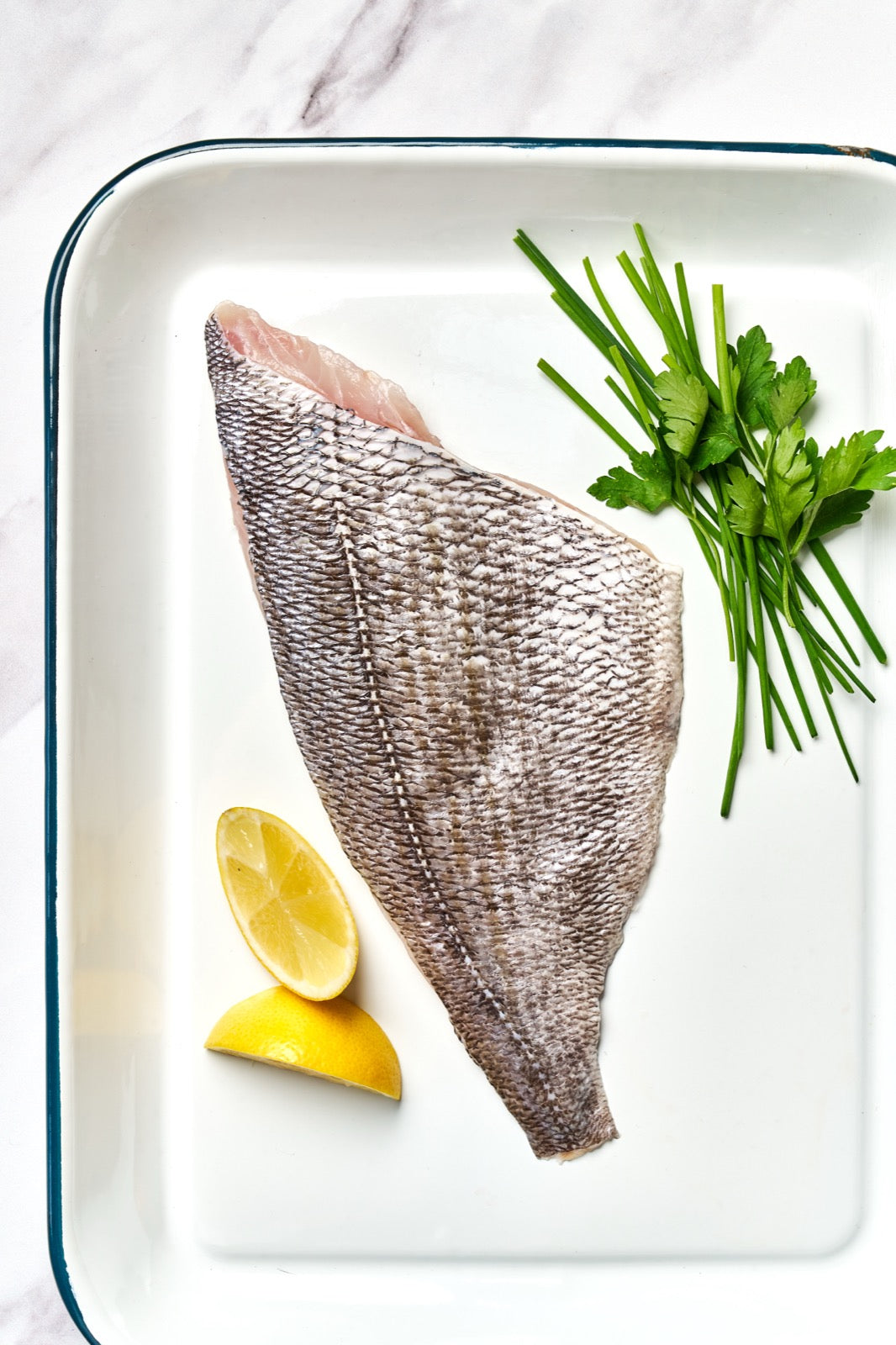 A portion of Black Bream fillet skin side up from Rockfish Online Seafood Market on a baking tray