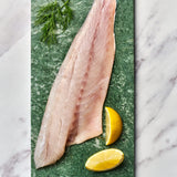 A portion of seabass fillet from Rockfish Online Seafood Market on a piece of marble