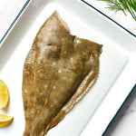 A portion of Plaice fillet skin side up from Rockfish Online Seafood Market on a baking tray